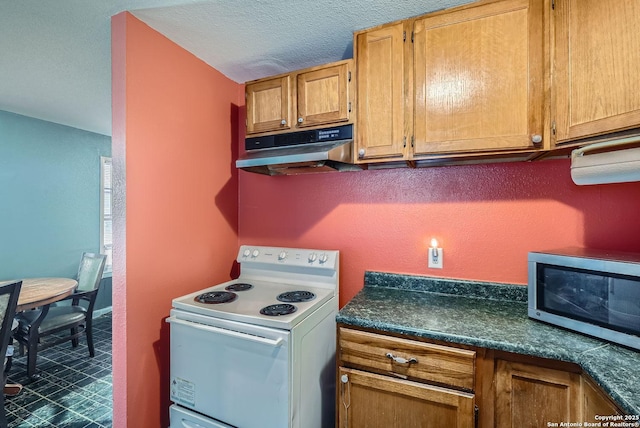 kitchen featuring white electric range oven and a textured ceiling