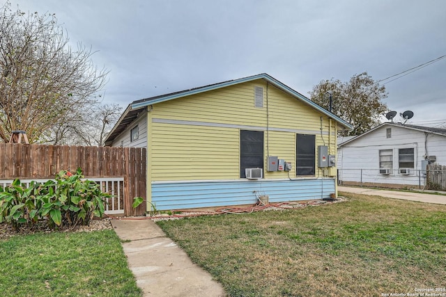 bungalow featuring a front yard and cooling unit