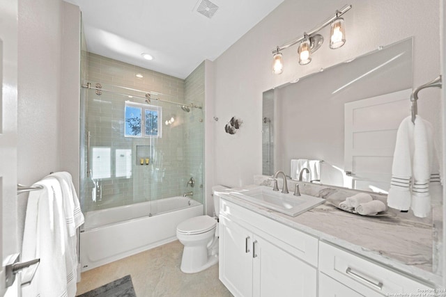 full bathroom featuring shower / bath combination with glass door, vanity, and toilet