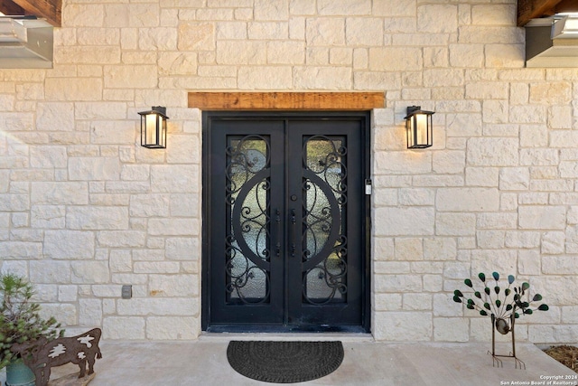 view of exterior entry featuring french doors