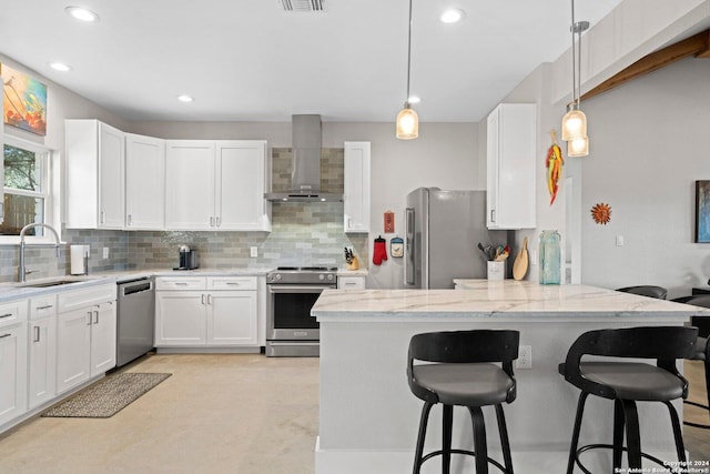 kitchen featuring wall chimney exhaust hood, sink, white cabinetry, and stainless steel appliances