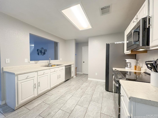 kitchen featuring white cabinetry, sink, and appliances with stainless steel finishes