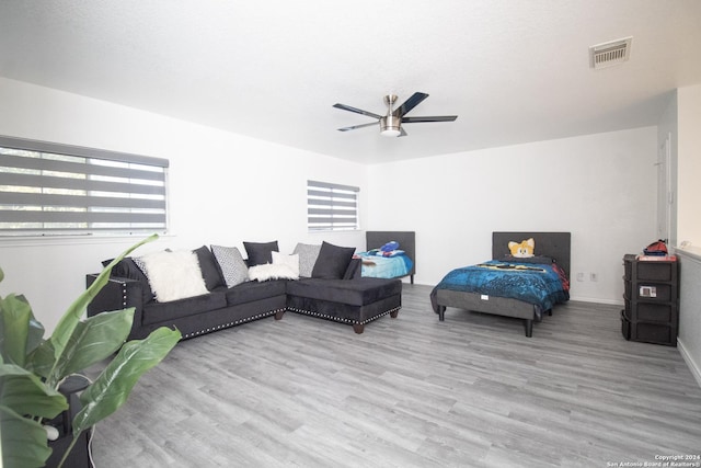 living room featuring ceiling fan and light hardwood / wood-style flooring