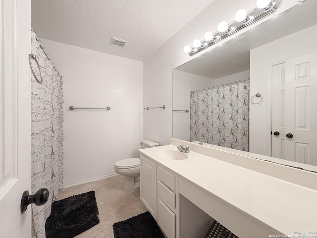 bathroom with vanity, a textured ceiling, and toilet