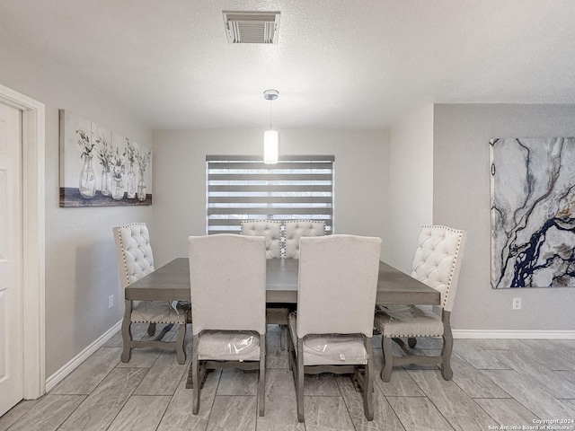 dining space with a textured ceiling