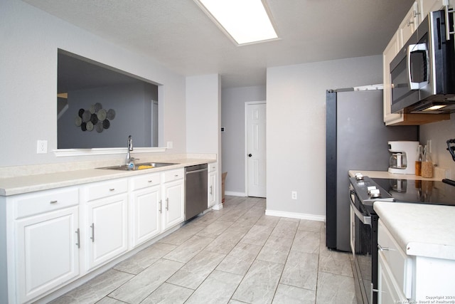 kitchen featuring white cabinets, stainless steel appliances, and sink