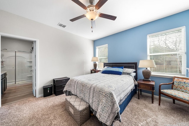 bedroom with light carpet, a ceiling fan, visible vents, and baseboards