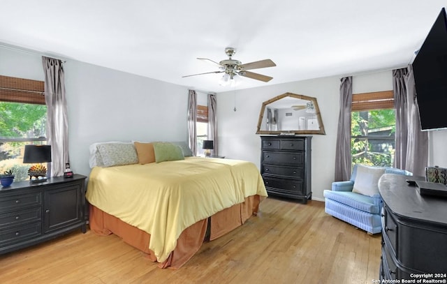 bedroom with ceiling fan and light wood-type flooring