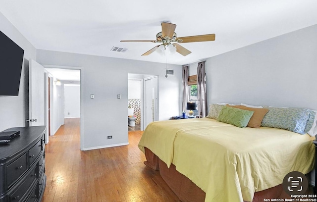 bedroom featuring hardwood / wood-style floors, connected bathroom, and ceiling fan