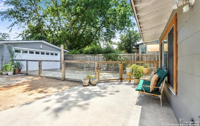 view of patio / terrace with a garage and an outdoor structure