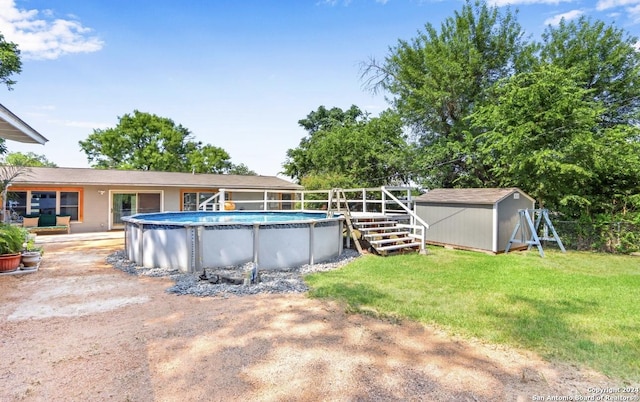 view of pool featuring a shed and a lawn