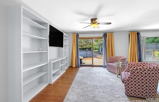 living room with ceiling fan and wood-type flooring