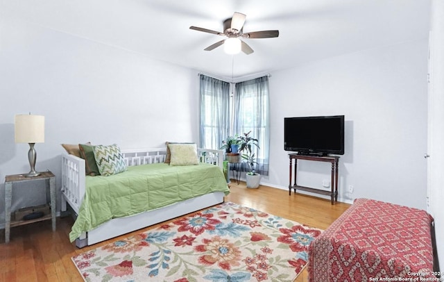 bedroom with ceiling fan and hardwood / wood-style flooring