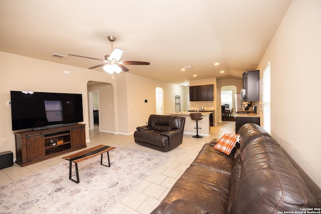 living room featuring ceiling fan and light tile patterned floors