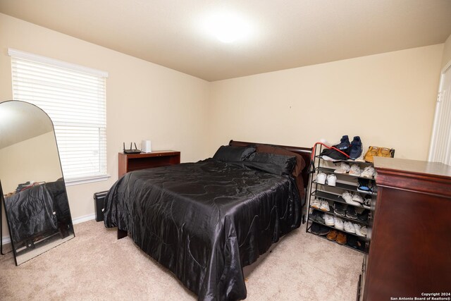 bedroom with light colored carpet