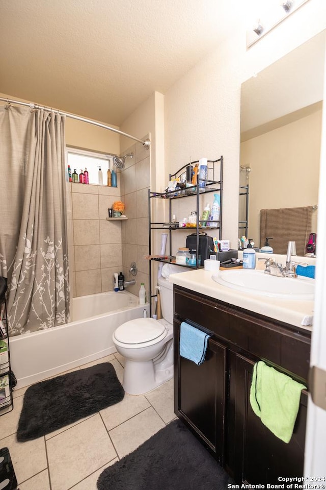 full bathroom featuring tile patterned floors, a textured ceiling, vanity, shower / bath combo with shower curtain, and toilet