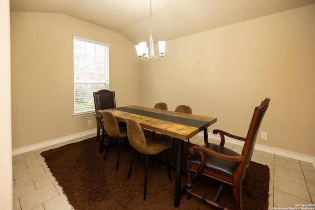 dining space with light tile patterned floors, an inviting chandelier, and lofted ceiling