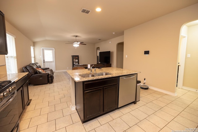 kitchen with light stone countertops, stainless steel dishwasher, ceiling fan, a kitchen island with sink, and sink