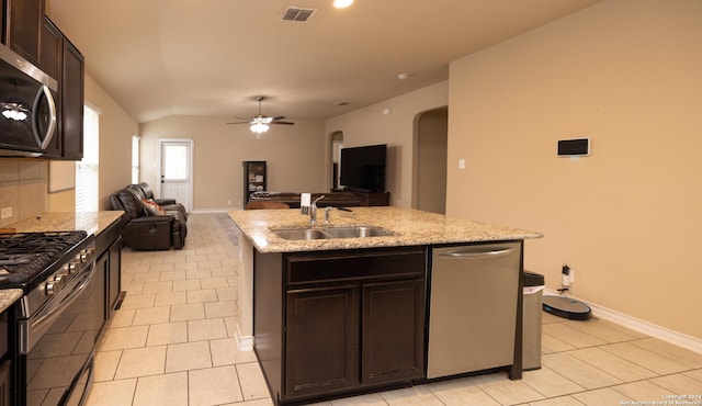 kitchen with sink, ceiling fan, an island with sink, appliances with stainless steel finishes, and dark brown cabinetry