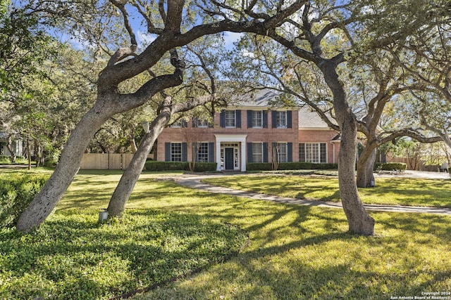 colonial-style house with a front lawn