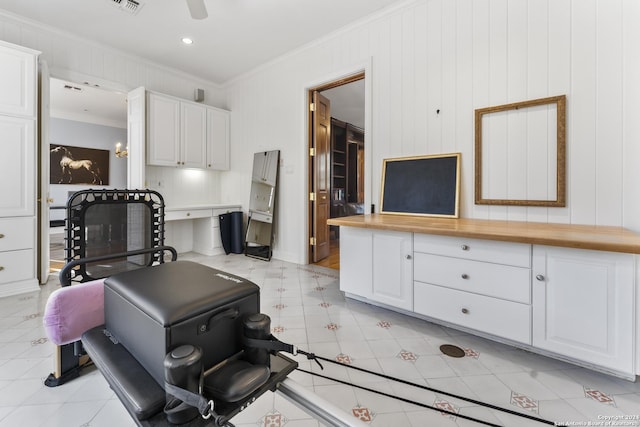 kitchen featuring white cabinets, wooden counters, and crown molding