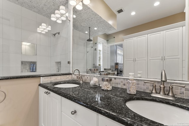 bathroom featuring vanity and an enclosed shower