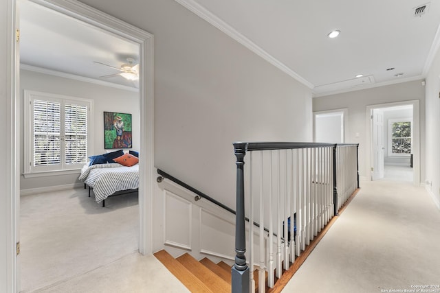 corridor with light colored carpet and crown molding