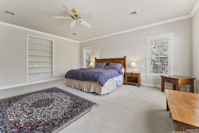 bedroom with carpet flooring, ceiling fan, and crown molding