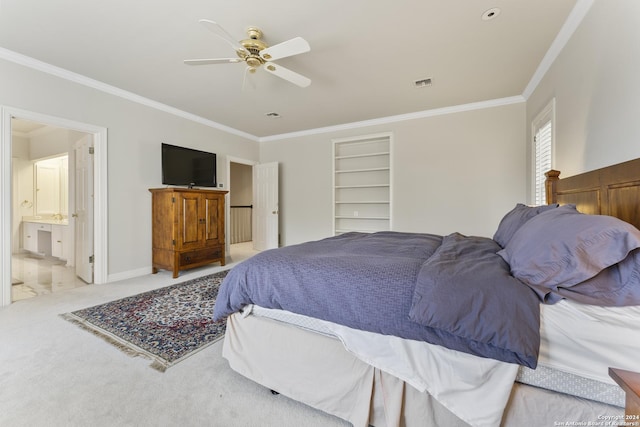 bedroom featuring ceiling fan, light colored carpet, ensuite bathroom, and crown molding