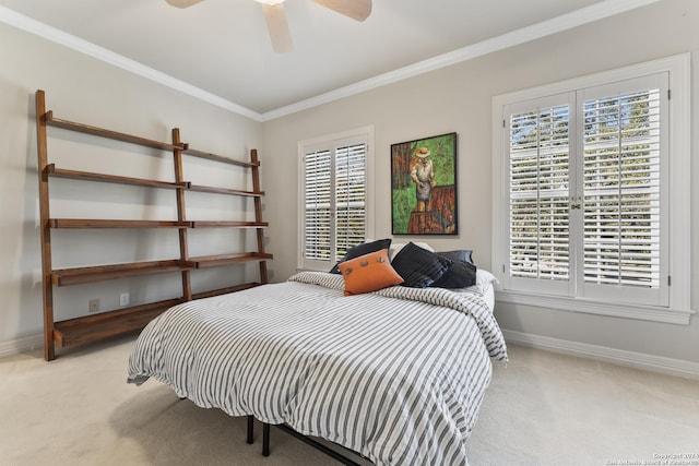 carpeted bedroom featuring ceiling fan and crown molding