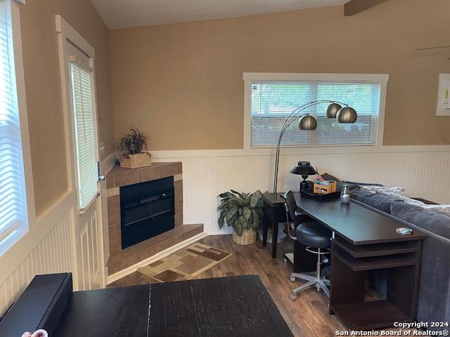 office with a fireplace and hardwood / wood-style flooring