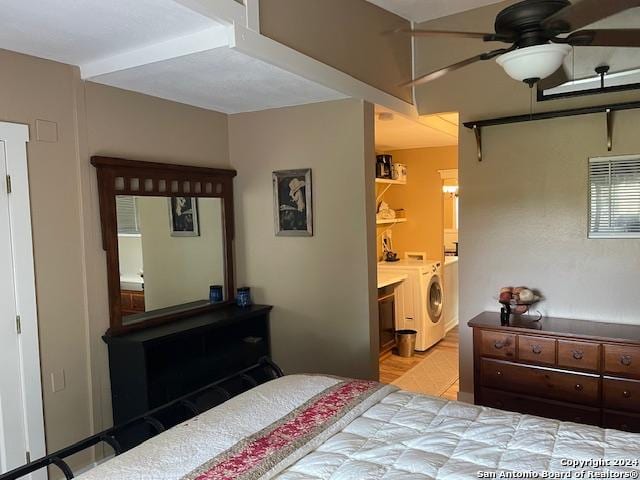 bedroom featuring ensuite bathroom, ceiling fan, and washer and dryer