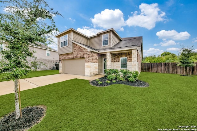 view of front of house with a front yard, a garage, and central air condition unit