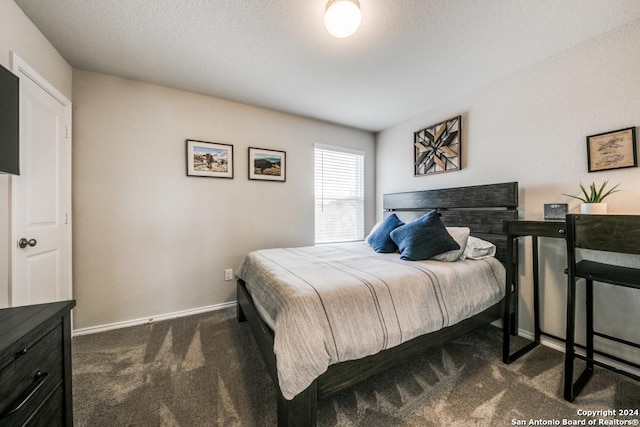 carpeted bedroom featuring a textured ceiling