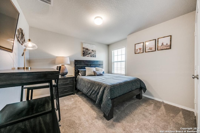 carpeted bedroom with a textured ceiling