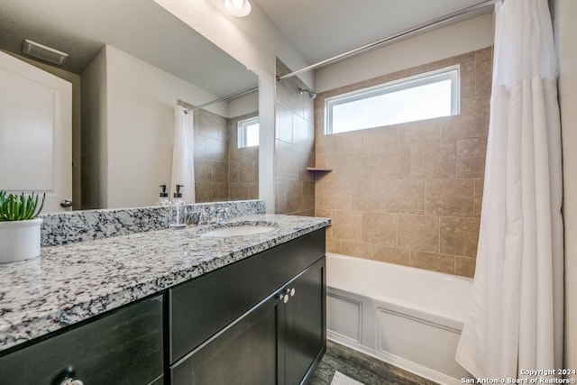 bathroom with wood-type flooring, vanity, and shower / bathtub combination with curtain