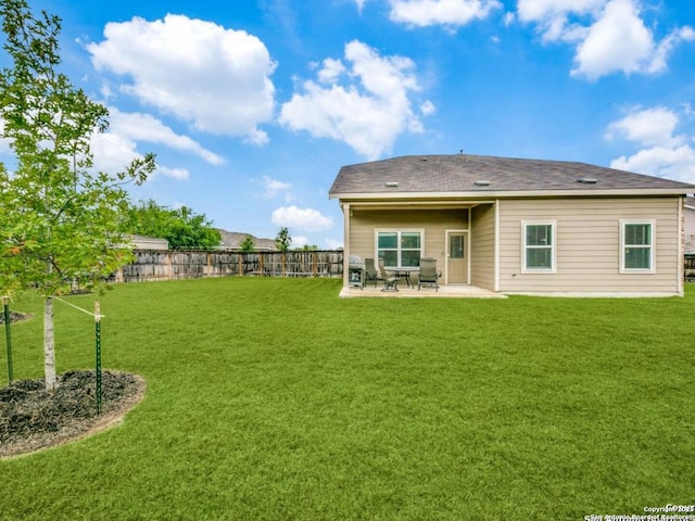 back of property with a patio area and a lawn