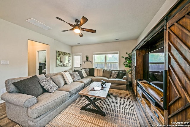 living room with ceiling fan and wood-type flooring