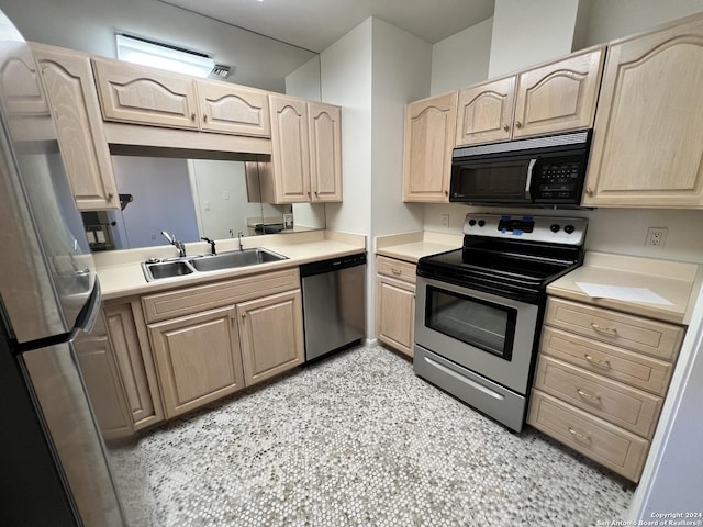 kitchen featuring light brown cabinets, stainless steel appliances, and sink