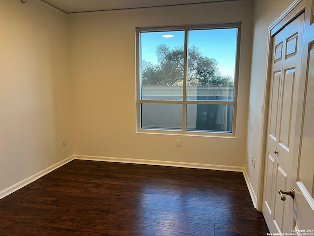 unfurnished room featuring dark hardwood / wood-style floors