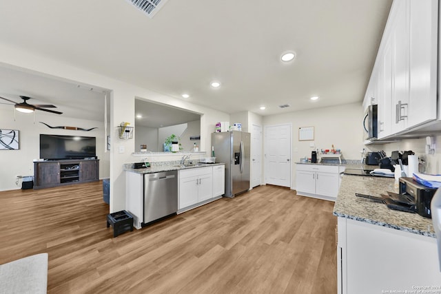 kitchen featuring white cabinetry, sink, ceiling fan, and stainless steel appliances