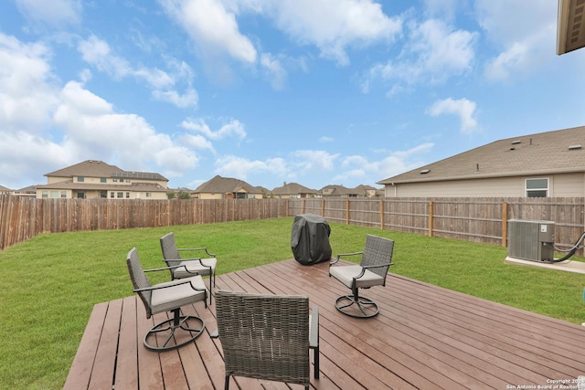 wooden deck with area for grilling, a lawn, and central air condition unit