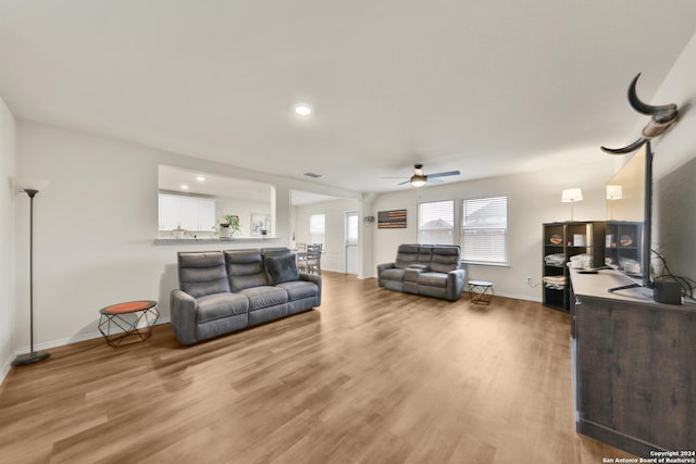 living room featuring hardwood / wood-style floors and ceiling fan