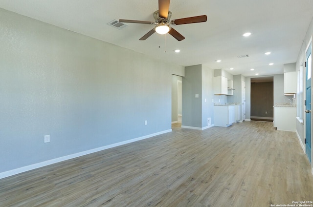 unfurnished living room with ceiling fan and light hardwood / wood-style floors