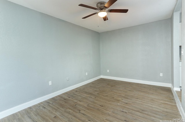 spare room featuring wood-type flooring and ceiling fan