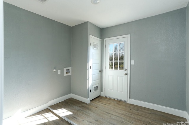 doorway to outside with light wood-type flooring