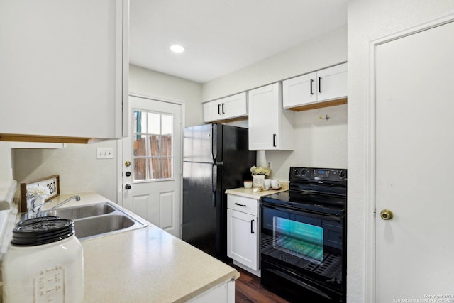 kitchen featuring sink, white cabinetry, dark wood-type flooring, and black appliances