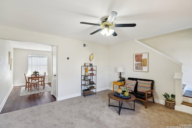 sitting room featuring ceiling fan and carpet