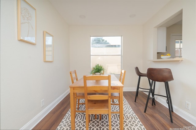 dining area featuring a healthy amount of sunlight and dark hardwood / wood-style flooring