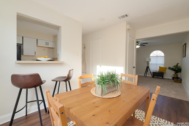 dining space with dark hardwood / wood-style flooring and ceiling fan